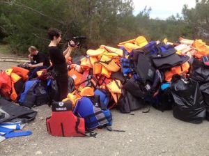 French Journalist filming the pile of life jackets collected by volunteers on Lesvos