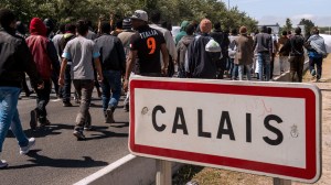 Migrants walk on June 17, 2015 towards the ferry port of Calais, northern France. Around 3,000 migrants built makeshift shelters in the so-called 'New Jungle' before trying to go to England. AFP PHOTO / PHILIPPE HUGUEN        (Photo credit should read PHILIPPE HUGUEN/AFP/Getty Images)